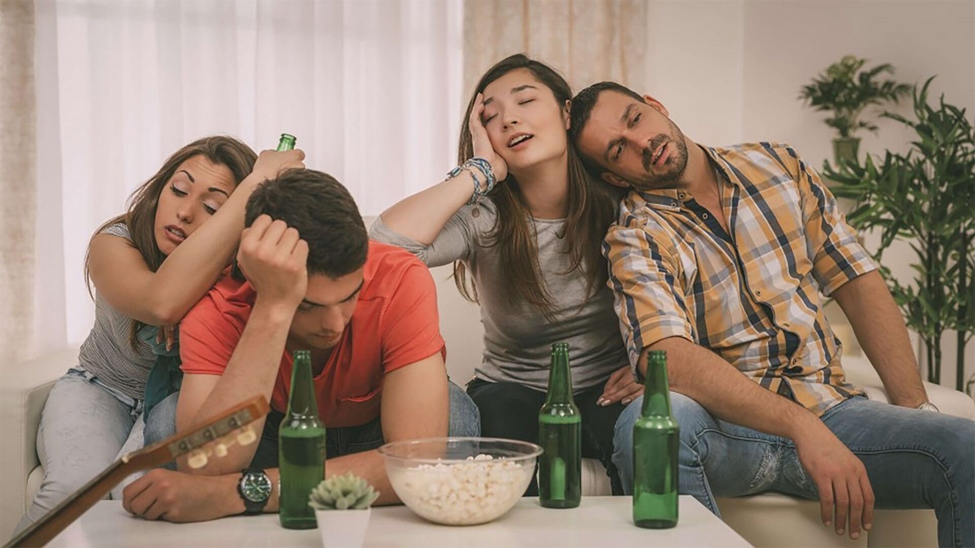 A group of people sitting around a table with beer.